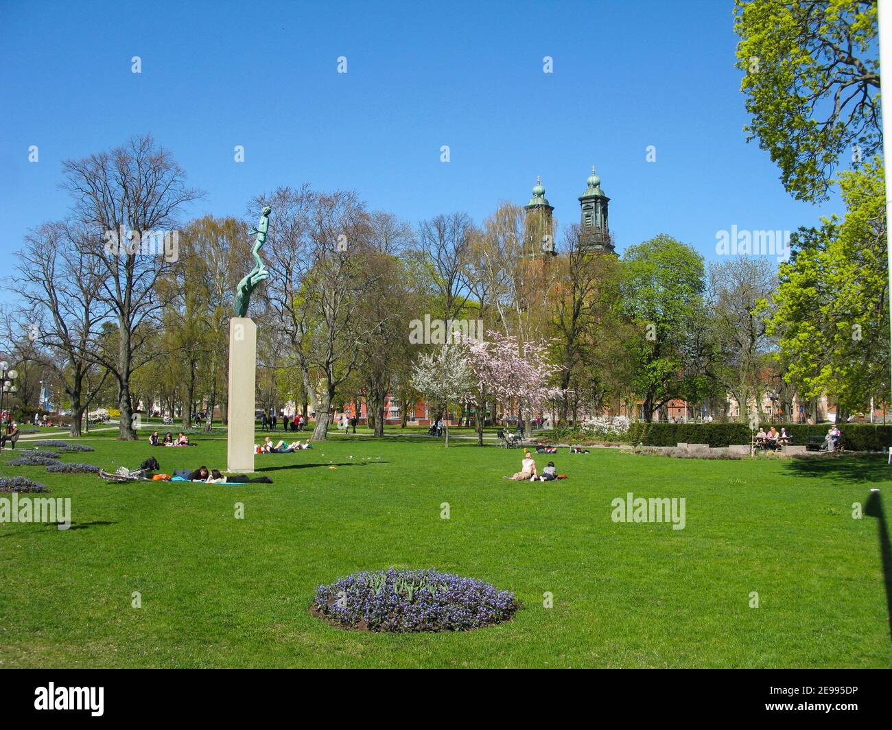 ESKILSTUNA Södermanland Carl Milles sculpture God`s hand in the City park with resting people in the spring Stock Photo